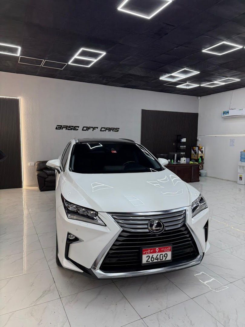 A white Lexus SUV in the Base off cars workshop