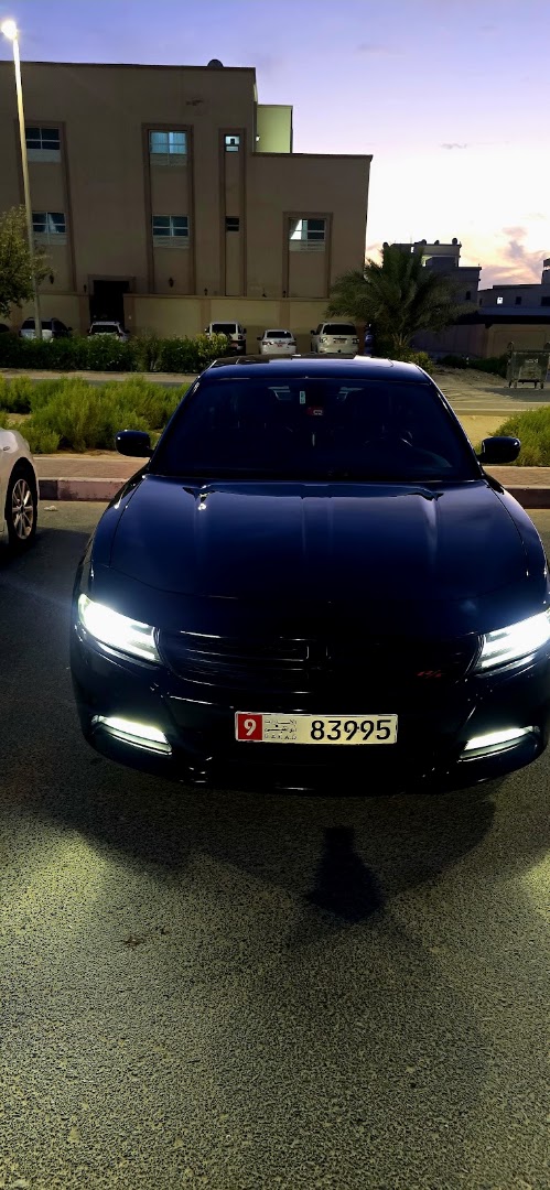 A car with headlights on after a night finish